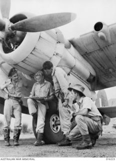 New Guinea. c. 1943. The RAAF crew of an Australian made Beaufort bomber aircraft discuss the results of a raid on Rabaul they had just carried out. From the left they are, Flying Officer G. ..