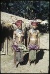 Bride price for Aina: young women wearing elaborate plumes head dresses, face paint, and other ornaments