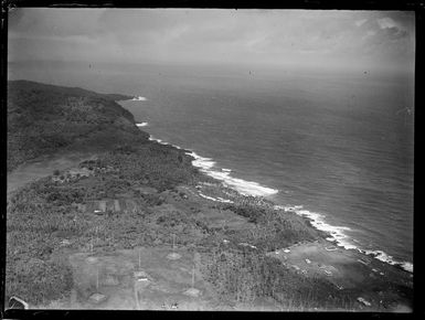 Aerial view of Tafuna Airfields' radio towers and coastal military camps amongst the palm trees, American Samoa