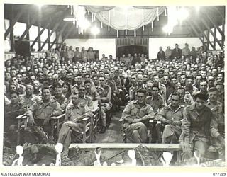 LAE BASE AREA, NEW GUINEA. 1944-12-27. AUSTRALIAN SERVICE PERSONNEL WAITING FOR THE CHRISTMAS CONCERT TO START IN THE AUDITORIUM OF THE 22ND WORKS COMPANY