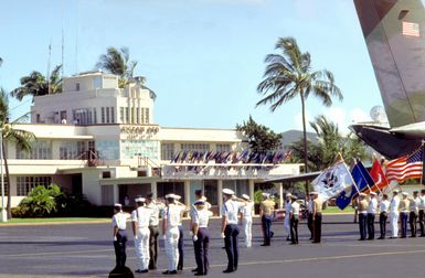 As the caskets containing remains suspected to be those of U.S. servicemen killed during the war in Vietnam are removed from a C-141B Starlifter a combined honor guard comes to present arms.