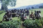 Crowd sitting, some wearing wigs, Wabag, Western Highlands, May 1963