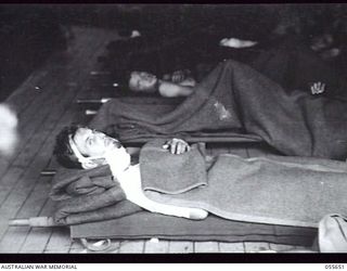 NEW GUINEA. 1943-07-28. AUSTRALIAN WOUNDED FROM NASSAU BAY BEING TAKEN OFF THE TUNGSIN