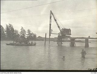 AITAPE, NORTH EAST NEW GUINEA. C. 1944-06. A NEW BRIDGE BEING BUILT ACROSS THE RAIHU RIVER BY NO. 7 MOBILE WORKS SQUADRON RAAF