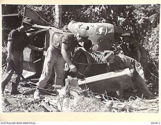 WEWAK AREA, NEW GUINEA. 1945-06-27. LANCE CORPORAL S.A. CRAWFORD (2) AND SAPPER D.H. HANNAN (3), MEMBERS OF 2/1 FIELD COMPANY, ROYAL AUSTRALIAN ENGINEERS, WORKING ALONGSIDE A RE-CAPTURED 8 DIVISION ..