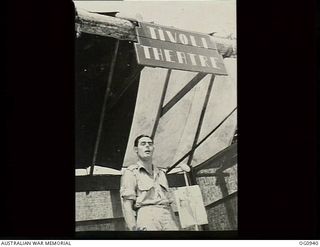 NADZAB, NEW GUINEA. C. 1944-02. LEADING AIRCRAFTMAN E. DUVAL OF BALMAIN, NSW, THE SQUADRON'S "JIVE-BOMBER" SINGING FROM THE STAGE OF THE TIVOLI THEATRE NAMED AFTER THE TIVOLI GIRL PERFORMERS ..