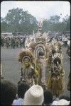 Port Moresby show: elaborately costumed dancers with feathered headdresses, necklaces strung with teeth, brightly dyed skits, barkcloth cape