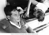 Rongelap family relaxing in a village on Rongelap Atoll, summer 1964