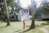 Federated States of Micronesia, village boy outside home in Chuuk State