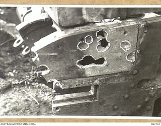 SCARLET BEACH AREA, NEW GUINEA. 1943-12-21. DAMAGE DONE TO THE RIGHT HAND SPONSON OF A MATILDA TANK BY A 37MM SHELL. THIS SECTION WILL BE REMOVED AND A NEW SECTION MADE AND WELDED INTO POSITION AT ..