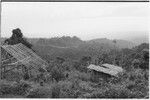 Wanuma: frame of house being built, Lutheran mission and government buildings in distance