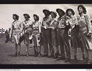 SOPUTA, NEW GUINEA. 1943-10-09. UNITED STATES ARMY OFFICERS AND NURSES TENSELY WATCH THEIR HORSE IN THE SOPUTA CUP AT THE RACE MEETING CONDUCTED BY THE 11TH AUSTRALIAN DIVISION. THE "RACEHORSES" ..