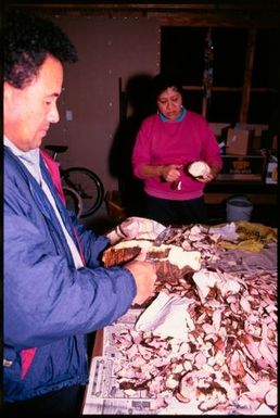 A man peeling vegetables for Niuean ear-piercing ceremony, Auckland