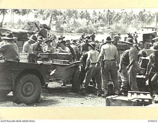 SIAR, NEW GUINEA. 1944-07-24. TROOPS OF THE 7TH INFANTRY BRIGADE UNLOADING AMMUNITION FROM BARGES AFTER THEY TOOK OVER THE AREA FROM THE 15TH INFANTRY BRIGADE