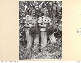 LAE, NEW GUINEA, 1945-05-18. SIGNALWOMAN V.M. JOHNSON (1), AND CORPORAL B.J. STOTT (2), PERSONNEL FROM THE AUSTRALIAN WOMEN'S ARMY SERVICE BARRACKS, TAKING PART IN AN ARMY AMENITIES TOUR OF THE ..