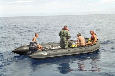 Members of Underwater Construction Team Two (UCT-2) and the Range Instruction Department from Point Magu, California are shown in a Zodiac boat while doing repair work on the Pacific Missile Range Facility off Kauai, Hawaii