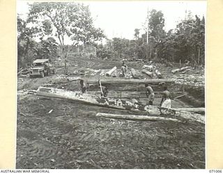 LAE - NADZAB ROAD, NEW GUINEA. 1944-03-09. CONSTRUCTION OF A CULVERT 87 1/2 MILES FROM WAU TO DRAIN THE SWAMP ON THE SOUTH SIDE OF THE ROAD. THE MARKHAM RIVER FLOWS ON THE NORTH OF THE ROAD