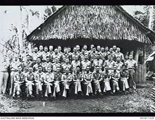 Milne Bay, Papua, 1944. Large group portrait of the members of No. 5 Base Squadron RAAF at the base occupied by the Headquarters (HQ) of RAAF Northern Command