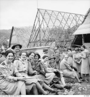Australian nurses of the 2/9 Australian General Hospital return to New Guinea. They arrive at a jungle hospital. In the background can be seen mess buildings under construction. Identified left to ..