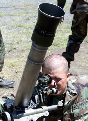 US Marine Corps Private First Class Hackworth from the 1ST Battalion, 3rd Marines, Weapons Company, sights in a M252 81mm Mortar during a training exercise at Pohakuloa Training Area on the Big Island of Hawaii