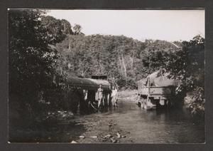 [Two Men with Trucks in Creek]