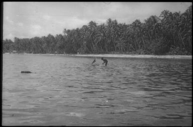 A boy learns to control a canoe, distant view : Carteret Islands, Papua New Guinea, 1960 / Terence and Margaret Spencer