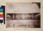 Missionary with wife outside house, Port Moresby, Papua New Guinea, ca. 1890