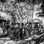 Men and older youth of the Niuhila faitu 'side' assembling on path prepatory to a march around village.