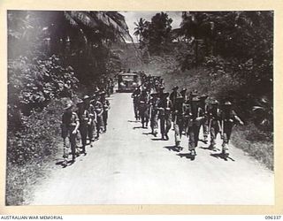 RABAUL, NEW BRITAIN, 1945-09-10. TROOPS OF 37/52 INFANTRY BATTALION MOVING UP THE ROAD TO RABAUL. THE MEN ARE PART OF THE AUSTRALIAN OCCUPATION FORCE WHICH OCCUPIED THE RABAUL AREA FOLLOWING THE ..
