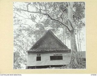 ORO BAY, NEW GUINEA. 1943-07. THE POST OFFICE, (LEFT), AND PAY OFFICE, (RIGHT), BUILT ON TO ONE END OF THE REGIMENTAL OFFICE AT THE 10TH FIELD AMBULANCE, AUSTRALIAN ARMY MEDICAL CORPS