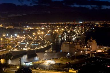 A high-angle view showing multi-national ships involved in the Rim of the Pacific (RIMPAC) 2006 Exercise, moored side-by-side at dusk during the 4th of July Independence Day Celebrations at Naval Base (NB) Pearl Harbor, Hawaii (HI). RIMPAC, the world's largest biennial maritime exercise, brings together military forces from Australia, Canada, Chile, Peru, Japan, the Republic of Korea, the United Kingdom and the US