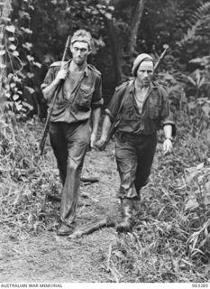 FAITA AREA, NEW GUINEA. 1944-01-07. WX12281 TROOPER T. TOWERS OF PERTH, WA (1) AND VX38890 CAPTAIN D. ST. A DEXTER OF FOOTSCRAY, VIC (2) MEMBERS OF A PATROL OF THE 2/2ND COMMANDO SQUADRON RETURNING ..