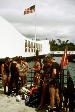 Members of Mobile Diving Salvage Unit 1 discuss plans at the USS ARIZONA Memorial site. Salvage Unit 1 is participating in the joint Navy/Park Service project SeaMark, a surveying and charting effort to assess submerged cultural resources in the Pacific