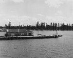 Helen Raitt (right, in white dress), waits for ship to dock in harbor on Christmas Eve, Nukualofa, Tonga