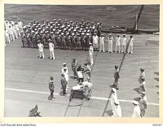 AT SEA OFF RABAUL, NEW BRITAIN. 1945-09-06. THE SURRENDER CEREMONY ON BOARD THE AIRCRAFT CARRIER HMS GLORY, SHOWING LIEUTENANT GENERAL V.A.H. STURDEE, GENERAL OFFICER COMMANDING FIRST ARMY, SIGNING ..