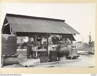 CAPE WOM, WEWAK AREA, NEW GUINEA. 1945-08-31. ONE OF THE COOKHOUSES, HEADQUARTERS ROYAL AUSTRALIAN ENGINEERS 6 DIVISION, SHOWING THE STRICT LAYOUT. MEMBERS OF HEADQUARTERS ROYAL AUSTRALIAN ..