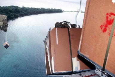 Residents of Peleliu wade out to recover a box dropped from a 374th Airlift Squadron aircraft during the delivery of boxes of gifts to islanders of the Federated States of Micronesia. Flown by crews from the 345th and the 21st Airlift Squadrons, the C-130 is participating in Christmas Drop '92, the 40th anniversary of the humanitarian effort. Every Christmas since 1952, food, clothing, tools and toys donated by residents of Guam have been delivered by air to 40 Micronesian islands