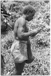 Larikeni talks to his ancestors with a betel nut, areca, and then eats it