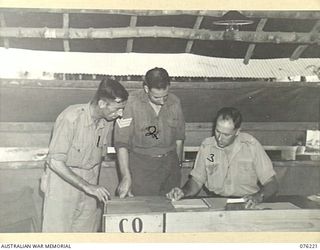 LAE, NEW GUINEA. 1944-09-28. THE ORDERLY ROOM, 22ND WORKS COMPANY, ROYAL AUSTRALIAN ENGINEERS. IDENTIFIED PERSONNEL ARE:- V500295 PRIVATE W.J.T. MORRIS (1); V76565 SERGEANT W.H.C. SUTTON (2); ..