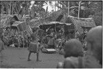 Mortuary ceremony, Omarakana: mourning women and children gathered for ritual exchange of banana leaf bundles