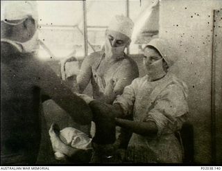 Port Moresby, Papua. 1942-12. A surgical operation in progress at No. 5 Casualty Clearing Station on a patient who had suffered bayonet wounds in fighting on the Kokoda Track. (Original housed in ..