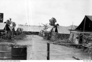 TADJI AIRSTRIP, AITAPE, NEW GUINEA. C.1944-06. OFFICERS LINES. THE TENT SECOND FROM THE END ON THE LEFT BELONGED TO 30542 FLYING OFFICER HENRY ARTHUR HURST, NO. 100 SQUADRON RAAF. THE BUILDING AT ..