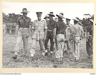 LAE AREA, NEW GUINEA, 1945-06-16. LT-GEN V.A.H. STURDEE, GOC FIRST ARMY (1) AND MAJ H.R. PARKE, COMMANDING OFFICER 2/3 FORESTRY COMPANY (2), INSPECTING THE UNIT DURING A PARADE ATTENDED BY ALL ..