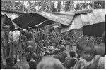 Mortuary ceremony, Omarakana: ritual exchange of banana leaf bundles, observed by anthropologist Annette Weiner (back to camera)