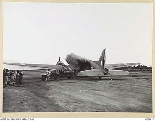 RABAUL, NEW BRITAIN. 1945-10-30. MAIL BEING LOADED ABOARD AN RAAF COURIER PLANE. THIS DOUGLAS C47 DAKOTA WAS THE FIRST COURIER AIRCRAFT TO LAND ON THE NEWLY RECONDITIONED LAKUNAI AIRSTRIP