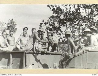 NEW GUINEA. ANTI-AIRCRAFT GUN CREWS COMING BACK TO BILLETS HAVING BEEN RELIEVED BY FRESH CREWS. ALL OF OUR PACIFIC OUTPOSTS ARE NOW HEAVILY DEFENDED BOTH BY FIGHTER AIRCRAFT AND ANTI-AIRCRAFT ..