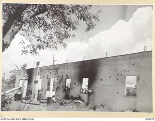 RABAUL, NEW BRITAIN, 1945-09-11. ALL BUILDINGS AND INSTALLATIONS AT RABAUL WERE DESTROYED BY ALLIED AIR ATTACKS. THIS PHOTOGRAPH SHOWS THE REMAINS OF THE BURNS PHILP STORE IN MANGO AVENUE, AS SEEN ..