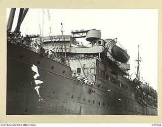 JACQUINOT BAY, NEW BRITAIN. 1945-02-24. THE SS "KATOOMBA", AN AUSTRALIAN ARMY TROOPSHIP, PULLING INTO THE WHARF ON HER ARRIVAL FROM AUSTRALIA WITH PERSONNEL OF THE 105TH CASUALTY CLEARING STATION