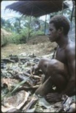Man sitting besides cooked pork