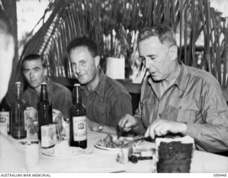 LAE, NEW GUINEA, 1945-12-25. THE RIGHT HONOURABLE J. B. CHIFLEY, PRIME MINISTER OF AUSTRALIA (3) HAVING CHRISTMAS DINNER AT NO 1 OTHER RANKS' MESS, FIRST AUSTRALIAN ARMY, DURING HIS VISIT TO THE ..